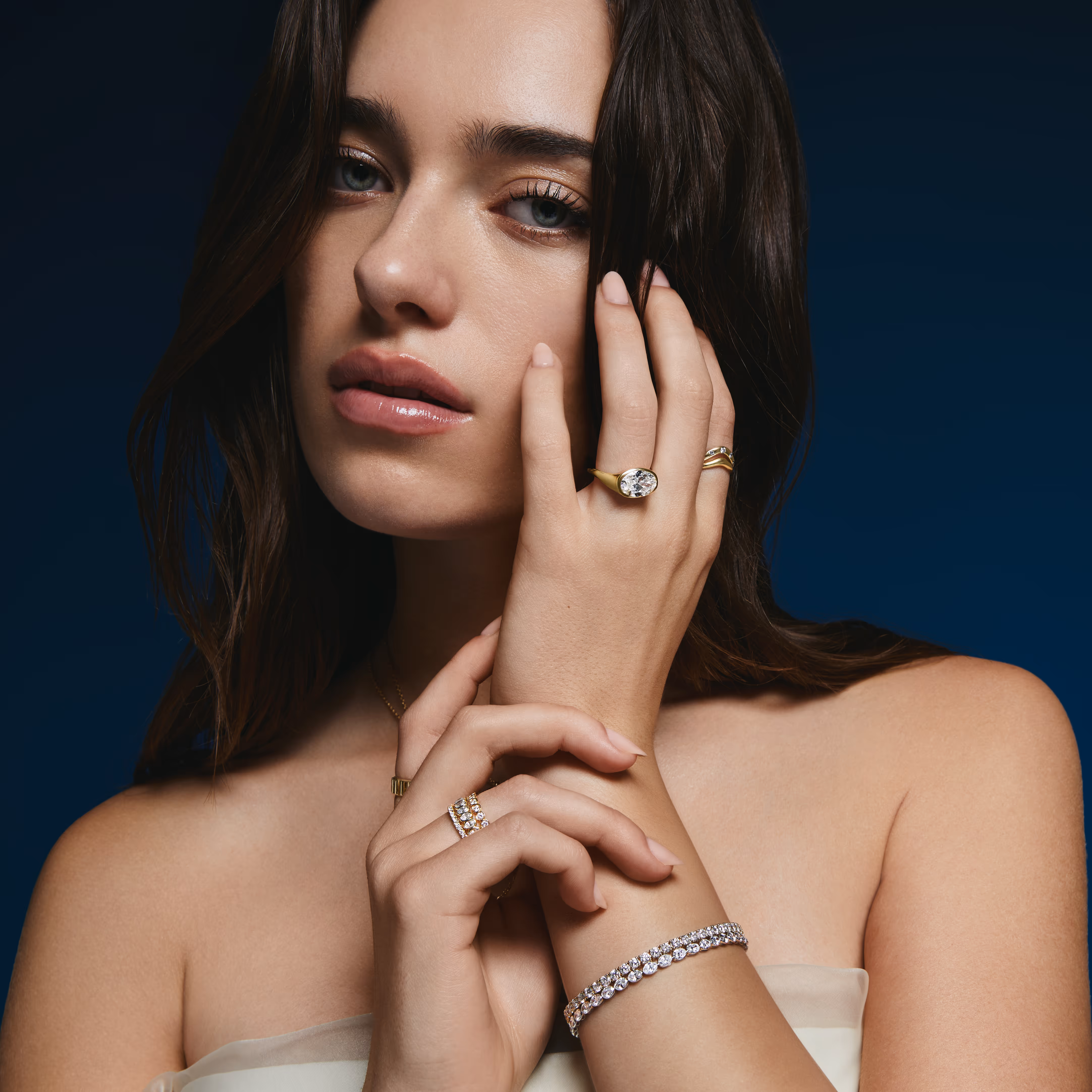 A close-up of an engagement ring with text overlay reading 'Find the Perfect Ring, Make it yours' against a dark background