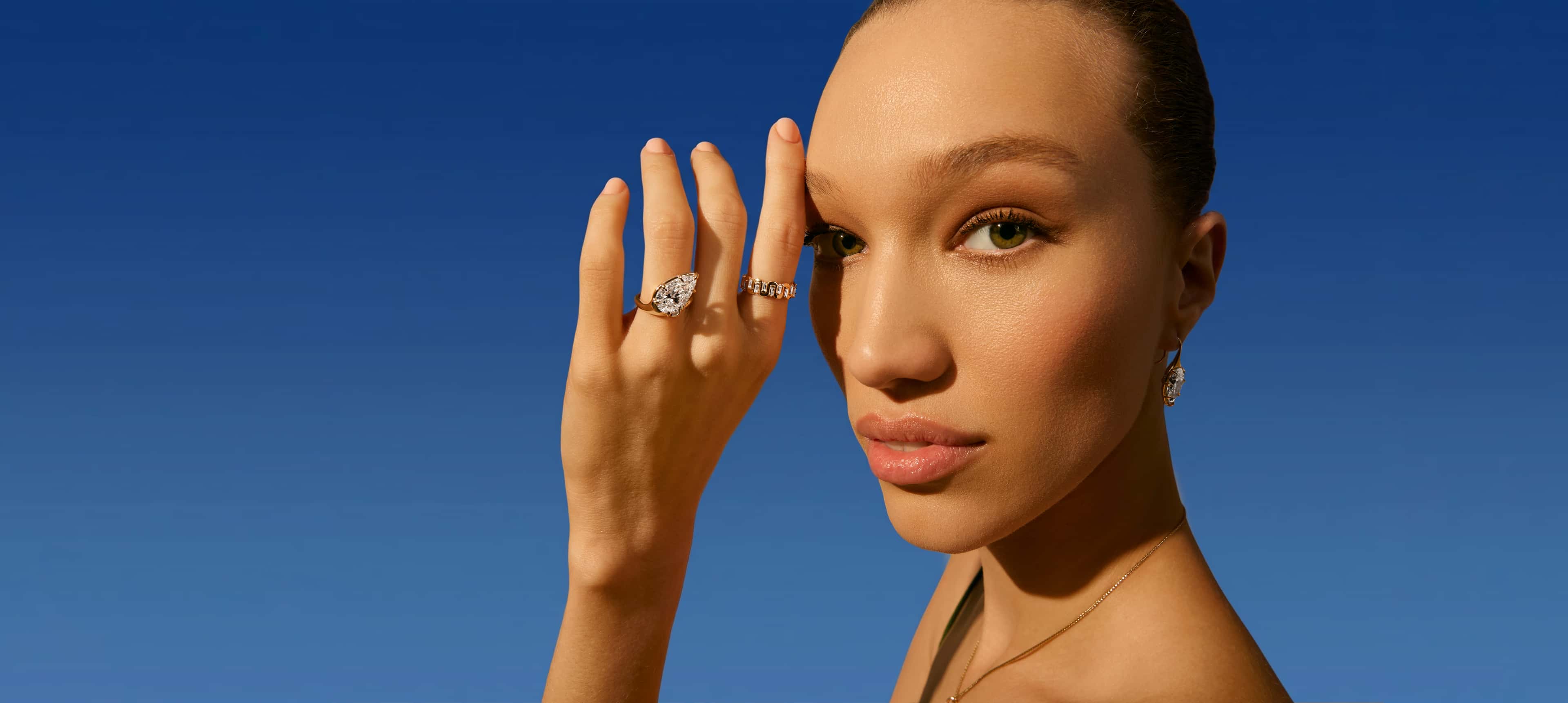 A close-up of an engagement ring with text overlay reading 'Find the Perfect Ring, Make it yours' against a dark background